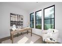 Bright office space with natural light, featuring a wooden desk, modern art, and a comfortable chair at 17201 Green Hill Rd, Charlotte, NC 28278