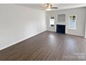 Bright living room featuring a cozy fireplace and light-filled windows, creating a warm and inviting atmosphere at 246 Tail Race Ln, Fort Mill, SC 29715