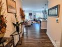 Inviting entryway view showcases the home's open-concept design with wood floors and modern decor at 2617 Manor Stone Way, Indian Trail, NC 28079