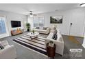 Bright living room featuring modern decor, a striped rug, and comfortable seating creating a welcoming space at 2643 Meadow Knoll Dr, Charlotte, NC 28269