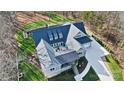 Aerial view of a beautiful luxury home surrounded by a well-manicured lawn and mature trees at 324 Patternote Rd, Mooresville, NC 28117