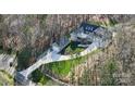 Overhead view of a well-maintained gray home with a long driveway and matching boat garage at 324 Patternote Rd, Mooresville, NC 28117
