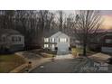 Aerial view of a two-story home featuring a landscaped yard, driveway, and cul-de-sac street at 3247 Bamburgh Ct, Charlotte, NC 28216