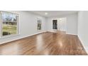 Bright living room with hardwood floors, large windows, and an inviting entryway at 410 Deerwood Dr, Gastonia, NC 28054