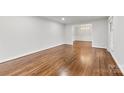 Spacious living room with hardwood floors and view into adjacent room at 410 Deerwood Dr, Gastonia, NC 28054