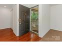 Bright foyer featuring hardwood floors and a view of the front porch, creating a welcoming entrance at 5011 Sharon Rd # J, Charlotte, NC 28210