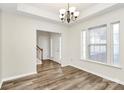 The light-filled dining area features wood floors and neutral paint, creating an inviting atmosphere at 5323 Dewmorn Pl, Charlotte, NC 28269