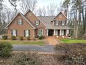 Inviting brick home with mature landscaping and a paved driveway at 720 9Th Nw Ave, Hickory, NC 28601