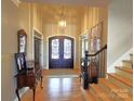 Grand foyer featuring hardwood floors, a chandelier, and a decorative front door at 720 9Th Nw Ave, Hickory, NC 28601
