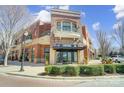 Striking red brick exterior building with a canopy, balcony, and manicured shrubs at 720 Governor Morrison St # 207, Charlotte, NC 28211