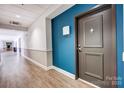 A well-lit hallway features two-tone walls and apartment doors at 720 Governor Morrison St # 207, Charlotte, NC 28211