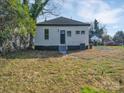 The backyard offers a spacious grassy area and a view of the home's exterior, complete with a classic black door at 720 Holmes St, Salisbury, NC 28144