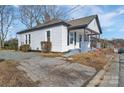 Charming home featuring white siding, a covered front porch, and an inviting, well-maintained lawn at 720 Holmes St, Salisbury, NC 28144