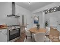 Modern kitchen with stainless steel appliances, adjacent dining area, and bright lighting at 720 Holmes St, Salisbury, NC 28144