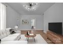 Bright living room features modern lighting, neutral decor, and wood flooring at 720 Holmes St, Salisbury, NC 28144