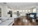Bright open-concept kitchen with white cabinets, stainless appliances, and center island at 805 Deep River Way, Waxhaw, NC 28173