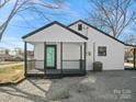 The house has a covered porch and a gravel patio with a modern white exterior at 811 Austin St, Albemarle, NC 28001