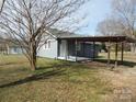 Home exterior featuring a covered porch, side entrance, and well-maintained lawn at 915 Chapel St, Landis, NC 28088