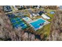 Aerial view of community amenities including a pool, tennis courts, and playground at 9623 Laurie Nw Ave, Concord, NC 28027