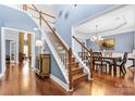 Elegant foyer with hardwood floors, staircase, and dining room view at 9623 Laurie Nw Ave, Concord, NC 28027