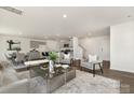 Open-concept living area with modern furnishings, a stylish rug, and a view into the dining and kitchen spaces at 1011 20Th Avenue Se Loop, Hickory, NC 28602