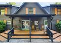 Inviting front porch with rocking chairs and a swing, perfect for relaxing in this log home at 106 Mcnaron Ln, Mooresville, NC 28117