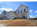 Exterior view showing a white two-story home with a covered front porch and a well-maintained lawn at 107 Megby Trl, Statesville, NC 28677