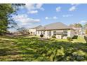 Spacious backyard with lush green grass, mature trees, and a cozy patio area at 1121 Mckee Farm Ln, Belmont, NC 28012