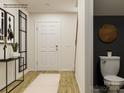 Modern foyer with wood flooring leads past a half bathroom with stylish decor at 13108 Hampton Bay Ln, Charlotte, NC 28262