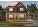 Beautiful brick home featuring a manicured lawn and a two-car garage at 13126 Macon Hall Dr, Mint Hill, NC 28227