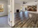 Spacious living room with fireplace, wood floors, and lots of natural light at 13903 Mallard Roost Rd, Charlotte, NC 28262