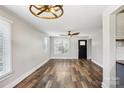 Bright living room featuring hardwood floors, a ceiling fan, and plenty of natural light from large windows at 14325 Rocky River E Rd, Davidson, NC 28036