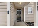 View of the front door showcasing the storm door, doorbell camera, and address numbers at 1541 Arborgate Dr, Rock Hill, SC 29732