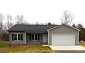 Beautiful one-story home with vinyl siding, black shutters, and attached one-car garage for added convenience at 203 S Hill Ave # 3, Albemarle, NC 28001