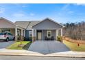 Inviting single-story home with a covered parking area and charming outdoor seating at 2802 15Th Avenue Se Pl, Hickory, NC 28602