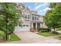 Charming two-story home featuring a two-car garage, stone accents, and lush green landscaping at 3004 Fallondale Rd, Waxhaw, NC 28173
