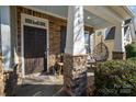 Inviting front porch with stone accents and comfortable hanging chair at 3004 Fallondale Rd, Waxhaw, NC 28173