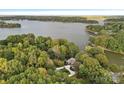 Aerial view of property showing lush trees and proximity to the lake at 4786 Heather Ln, Denver, NC 28037