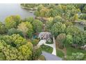 Aerial view showing backyard pool, beautiful landscaping, and lake access at 4786 Heather Ln, Denver, NC 28037
