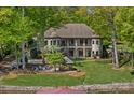 Beautiful lakefront home featuring a two-story porch and inviting outdoor spaces at 4786 Heather Ln, Denver, NC 28037