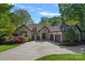 Charming stone-front home with a three-car garage and manicured landscaping at 4786 Heather Ln, Denver, NC 28037