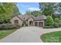 Charming stone-clad home featuring a spacious driveway and mature landscaping at 4786 Heather Ln, Denver, NC 28037