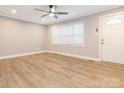 Bright living room with new flooring, crown molding, a ceiling fan, and a large window at 608 E Matthews St, Matthews, NC 28105