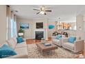 Bright living room with hardwood floors, fireplace, and open to dining area at 9724 Walkers Glen Nw Dr, Concord, NC 28027