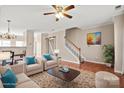 Inviting living room with staircase, hardwood floors, and open floorplan at 9724 Walkers Glen Nw Dr, Concord, NC 28027