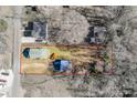 Aerial view of the property with lot lines, including the house, detached garage, and surrounding landscape at 102 Fire Department Dr, Belmont, NC 28012