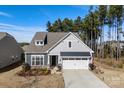 Charming home with a manicured lawn, two-car garage, and a mix of stone and siding accents at 1029 Dali Blvd, Mount Holly, NC 28120