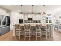 Spacious kitchen featuring white cabinets, a large island with seating, and stainless steel appliances at 1029 Dali Blvd, Mount Holly, NC 28120