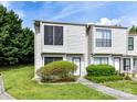 Inviting townhouse with manicured lawn and shrubbery leading to the front door at 11020 Carmel Crossing Rd, Charlotte, NC 28226
