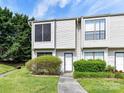 Inviting townhouse with manicured lawn and shrubbery leading to the front door at 11020 Carmel Crossing Rd, Charlotte, NC 28226